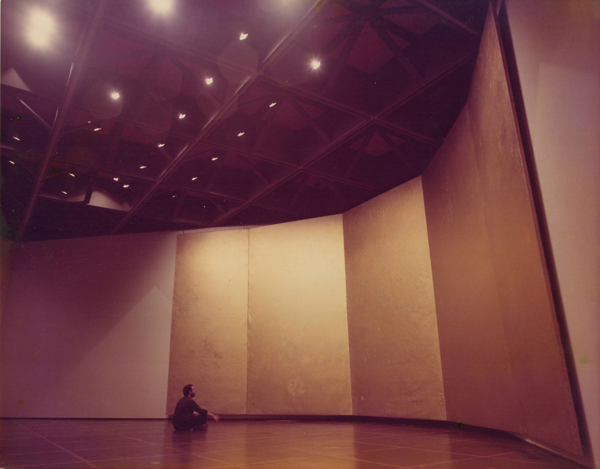 Michael Tracy sits before a massive abstract artwork in his first museum show at McNay Art Institute.