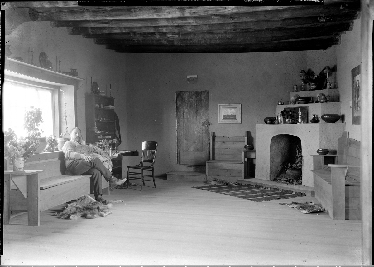 Historical photograph of painter Eanger Irving Couse in his Taos living room, from the Couse-Sharp Historic Site.