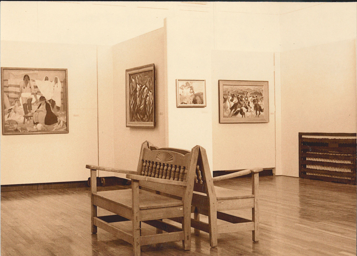 1980s photograph of the Harwood Museum in Taos, showing a painting that would later be stolen. The successful recovery of two stolen Taos Society of Artists paintings is one top Southwest Art News 2025 headline.