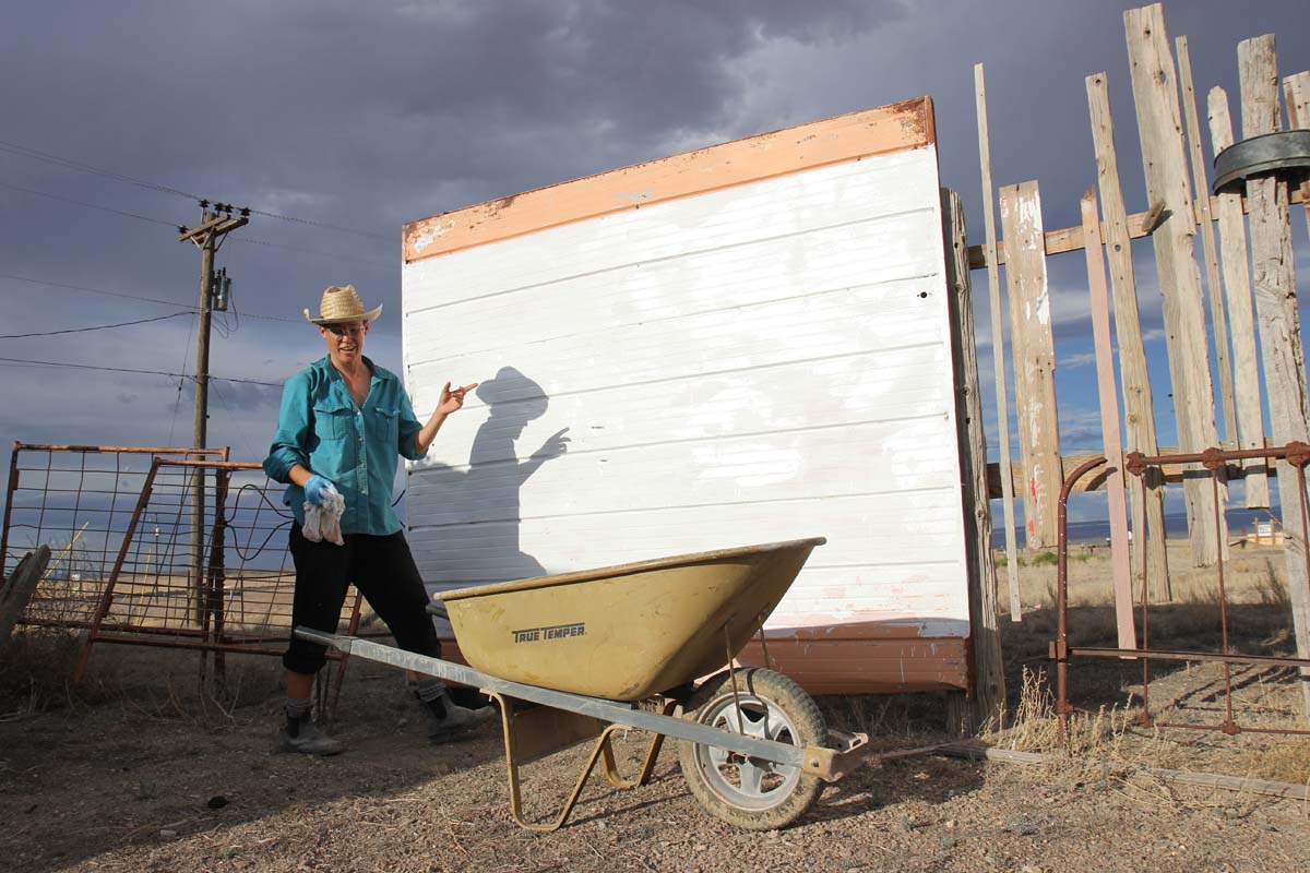 Eileen Muza painting a wall white for projections.
