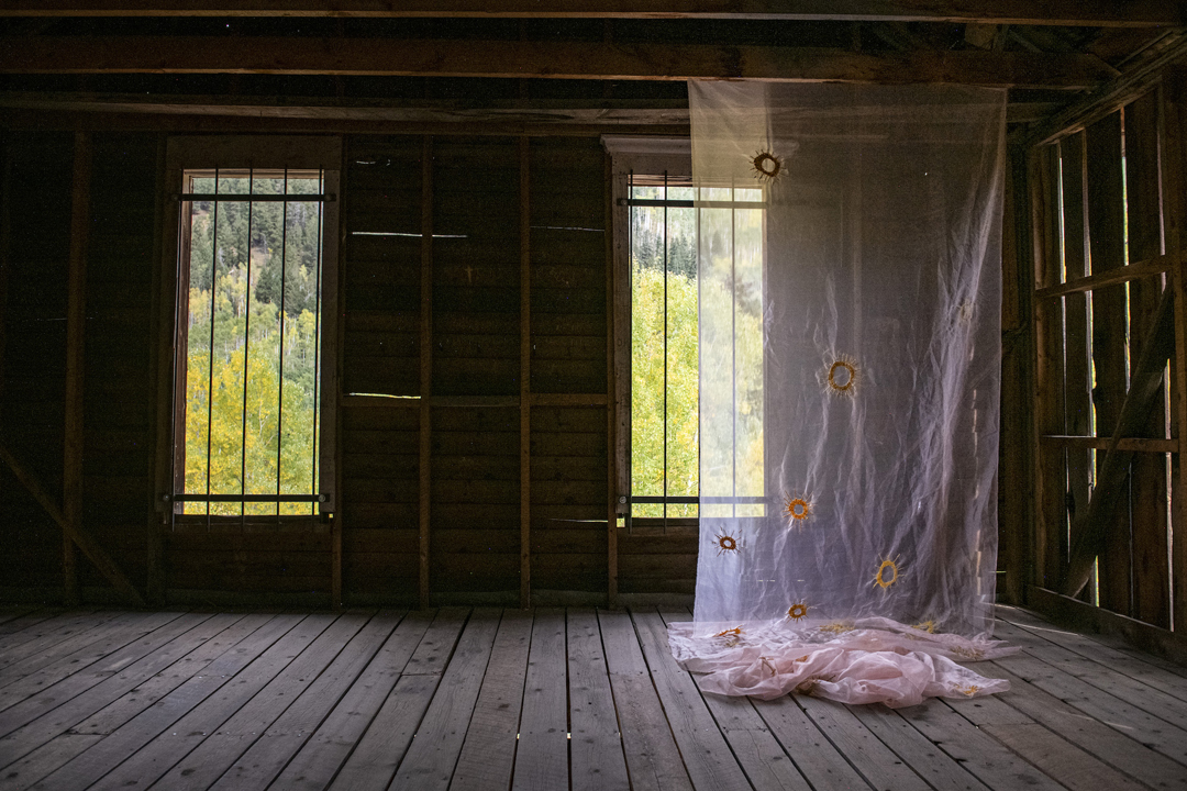 Ghostly installation view of Kaitlyn Tucek's The Lilac Hour, which took place in an abandoned Colorado village.