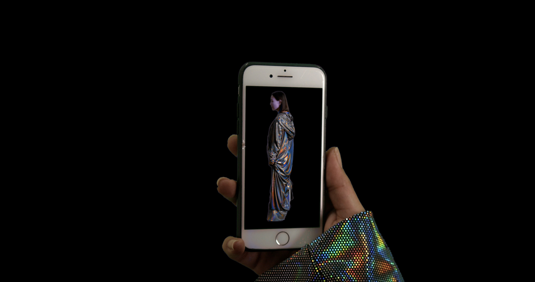 A humanoid oracle appears on an iPhone in a contemporary new media artwork about humans, cyborgs, and the AI revolution.