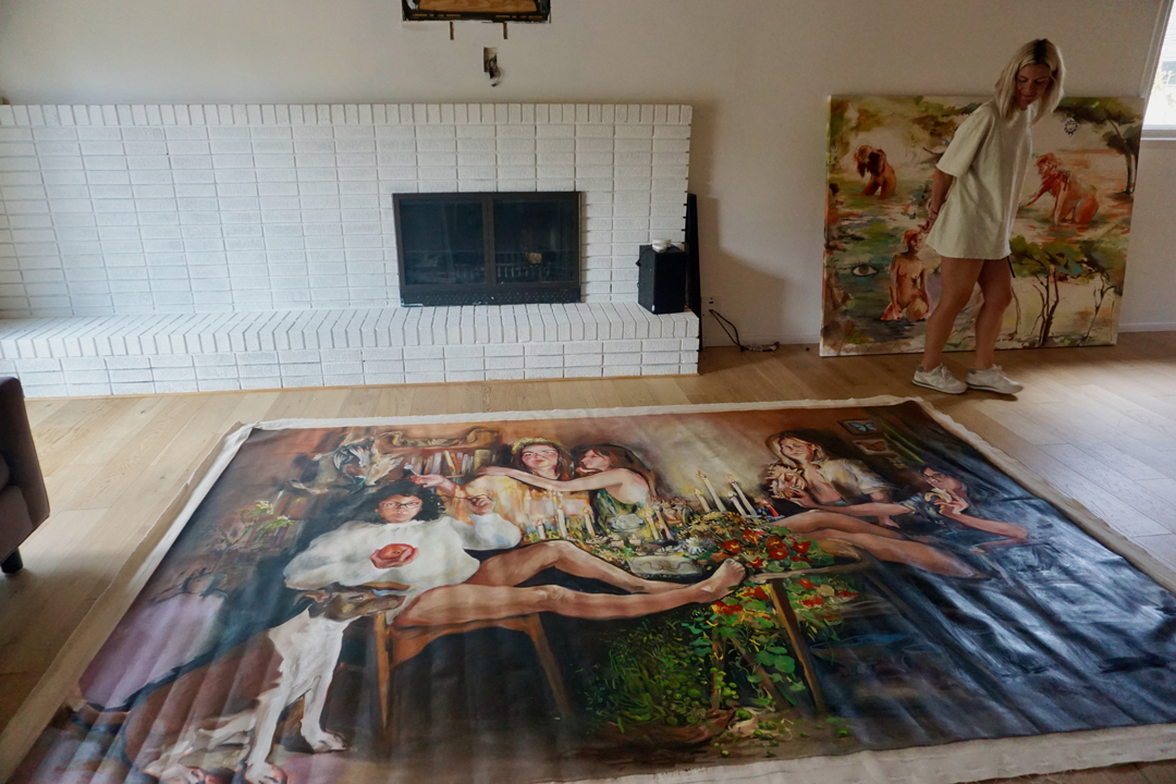 Artist Kaitlyn Tucek paces around a massive painting in her Denver studio.
