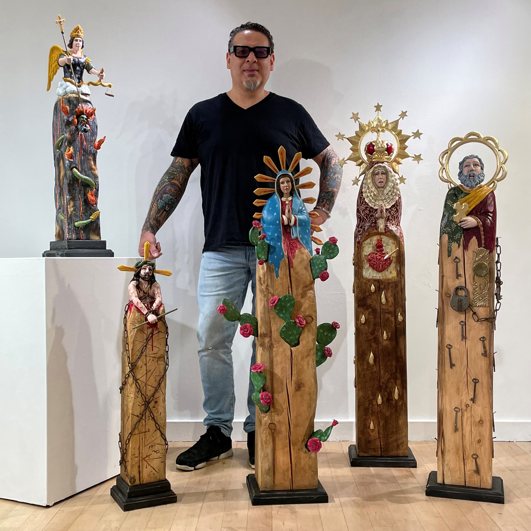 Portrait of artist Arthur Lopez with his contemporary bulto artworks, which he has exhibited at Traditional Spanish Market in Santa Fe.