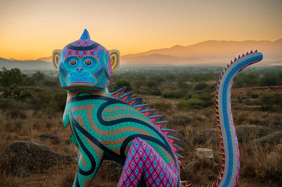 Monkey referencing the Oaxacan alebrije tradition in a sweeping desertscape. Southwest Botanical Gardens have transformed into living contemporary art museums.