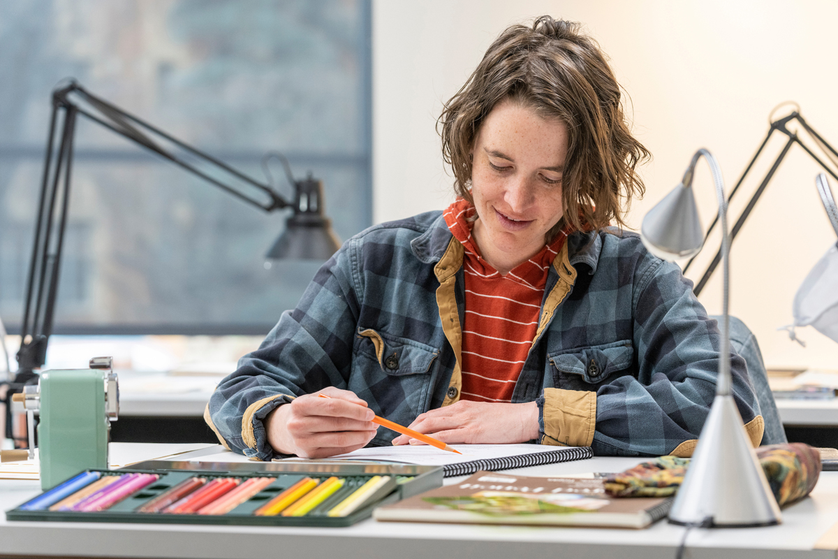 A child sketches with colored pencils in an art class at Denver Botanic Gardens. Guide to contemporary art in Southwest Botanical Gardens.