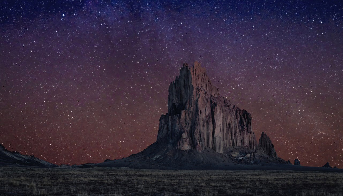 An image of Shiprock under the brilliant night sky by Steven J. Yazzie, on view in Life on Mars at SMoCA.
