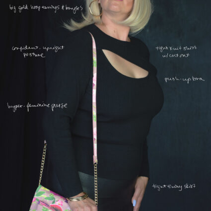 Photograph of artist jesse lovell in one of their disguises named Chelsea, featuring a woman in a blonde wig wearing a black dress and pink floral purse.