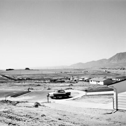 Black and white photo by Robert Adams showing the frame for a tract home in Colorado Springs.