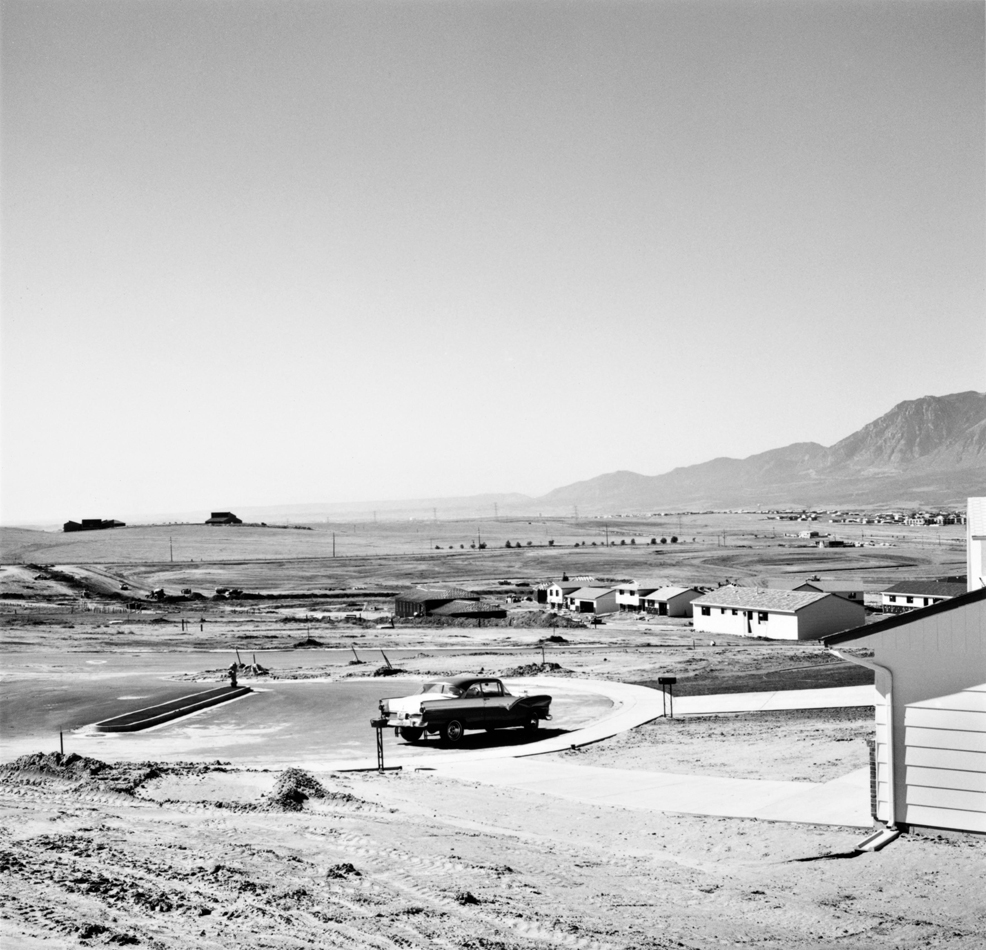 Black and white photo by Robert Adams showing the frame for a tract home in Colorado Springs.