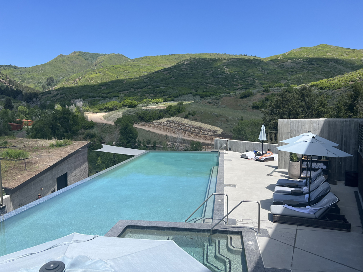 A view of the pool and nearby mountains at The Lodge at Blue Sky, a must-stay in the Park City Art Guide.