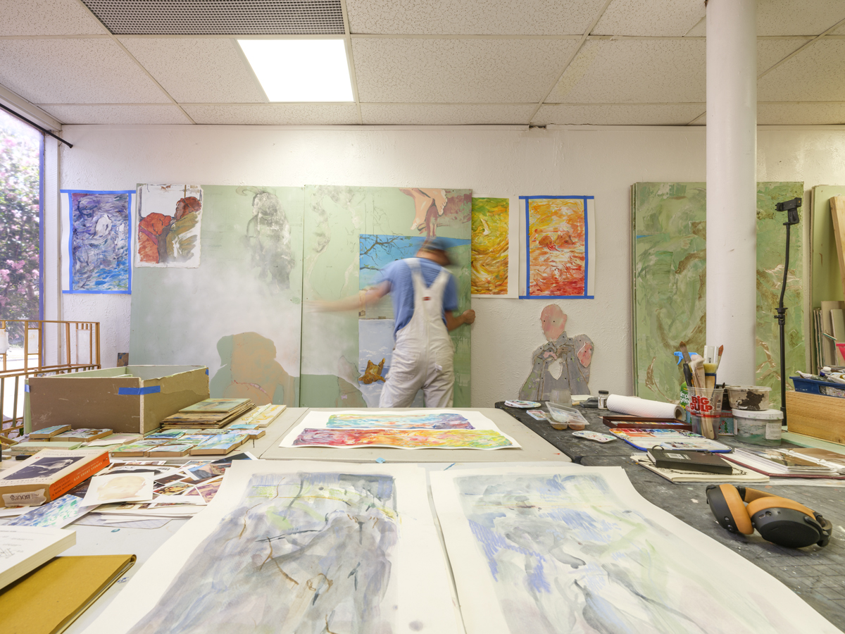 Eli Ruhala moves a painting in his Dallas studio.
