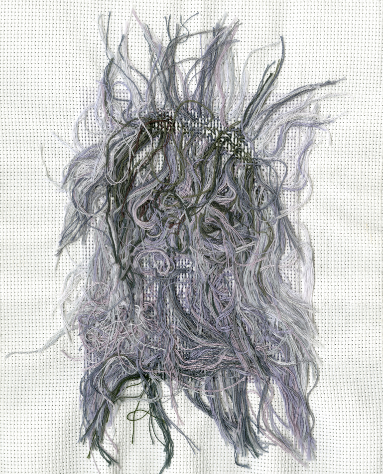 Threads on the back of a black and white cross-stitch artwork by Utah-based artist Nancy Rivera.