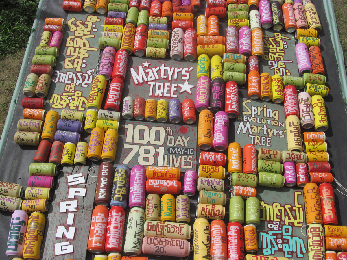 Sitt Nyein Aye Martyrs' Tree installation comprising painted aluminum cans and text.
