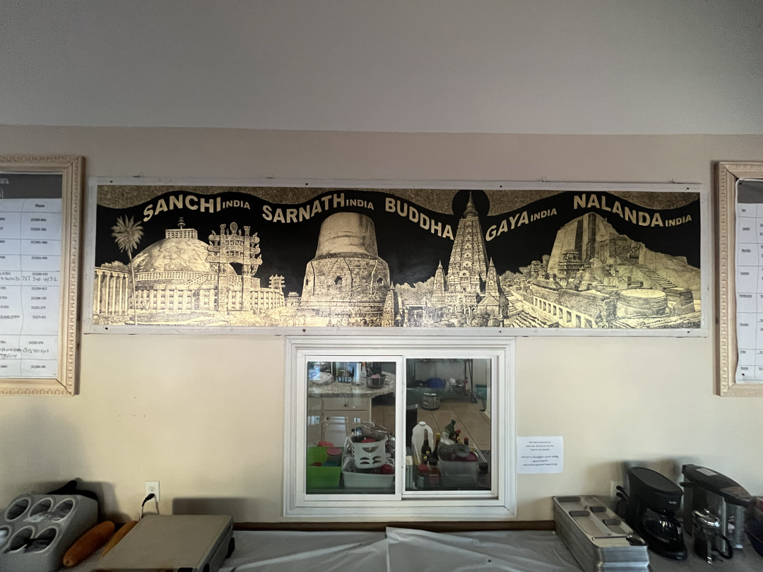 Black and gold painting by Sitt Nyein Aye depicting Indian Buddhist temples, in the dining hall of Sitagu Buddha Vihara in Austin, Texas.