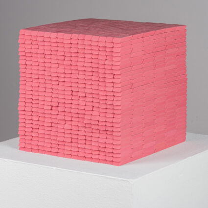 Photo of Colorado-based artist Joel Swanson's sculpture, a cube made out of Pink Pearl erasers.