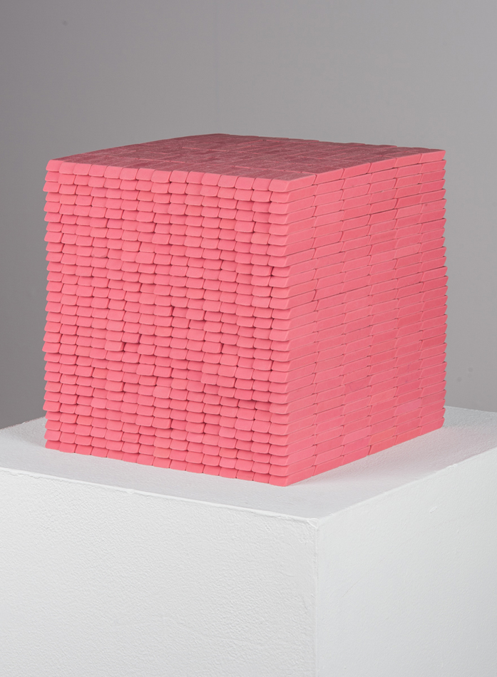 Photo of Colorado-based artist Joel Swanson's sculpture, a cube made out of Pink Pearl erasers.
