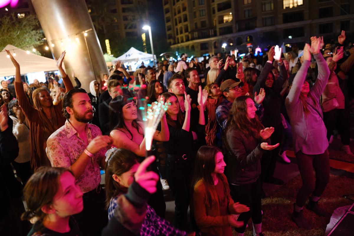 Exuberant crowd at the Canal Convergence festival in Scottsdale, an essential stop on an Arizona art road trip.