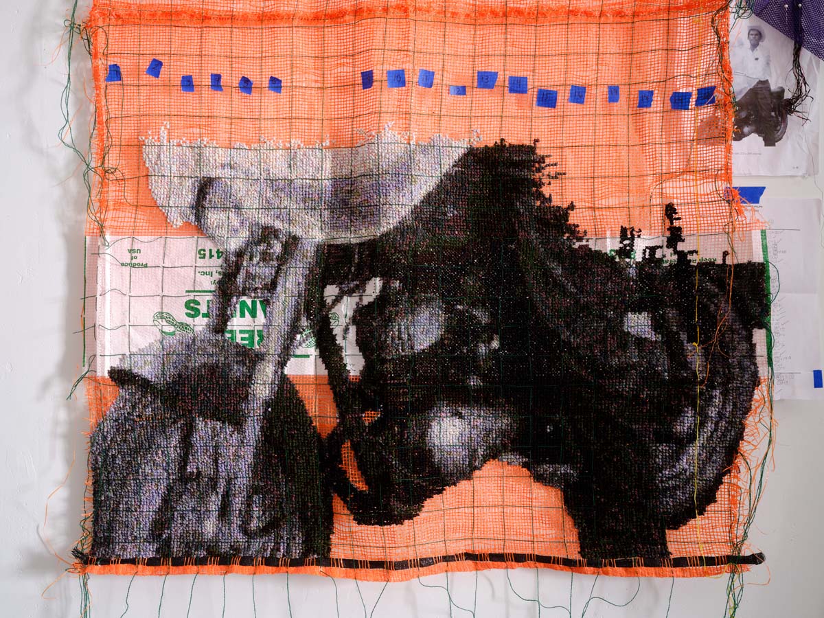 Work by Gloria Martinez-Granados, depicting a motorcycle in cross-stitch on produce bags.