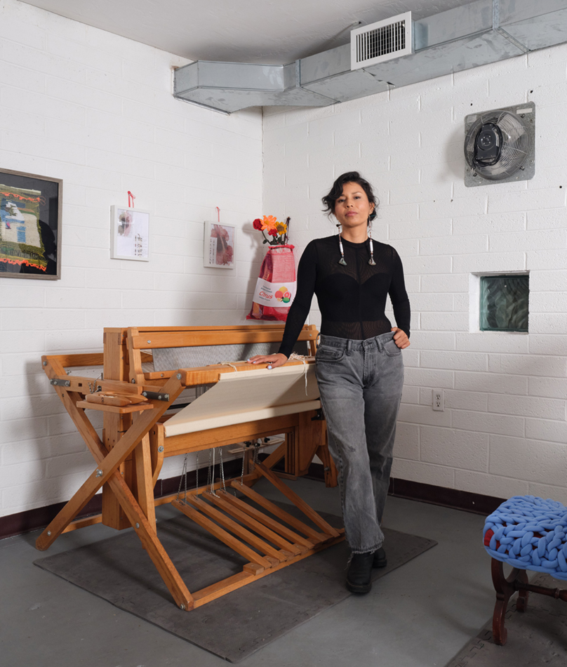 Gloria Martinez-Granados in her studio standing next to a loom.