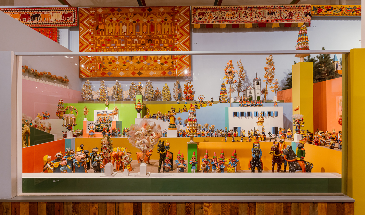View of an exuberantly packed display in the Alexander Girard exhibition at Museum of International Folk Art.