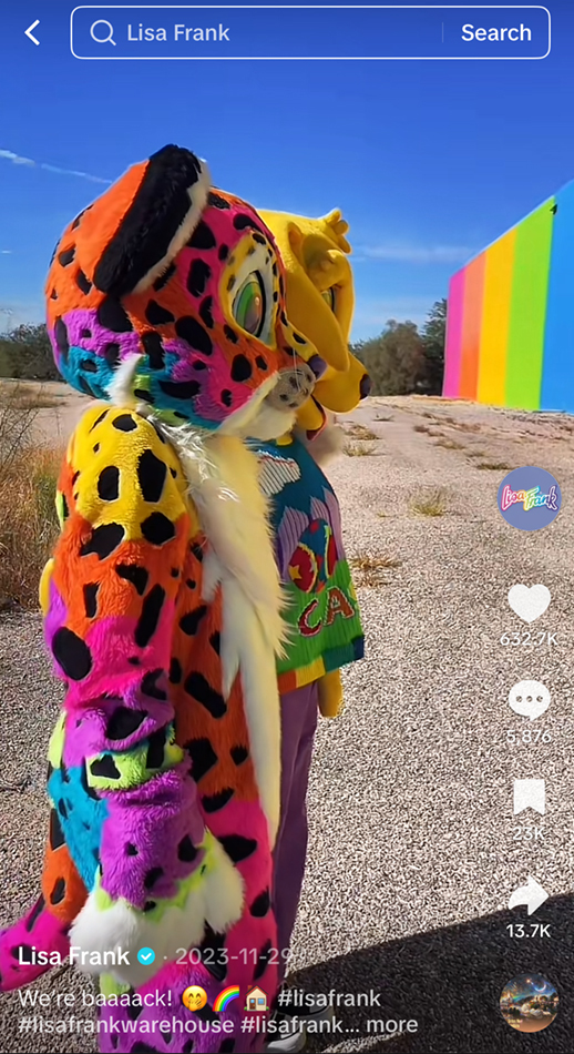Mascots in front of the Lisa Frank warehouse with the caption, "We’re baaaack!" TikTok screenshot from the official @lisafrank account, 2023.