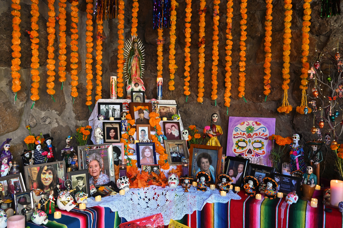 Altar piece with photos, candles, and marigolds at Celebraciones de la Gente in Sedona, Arizona.