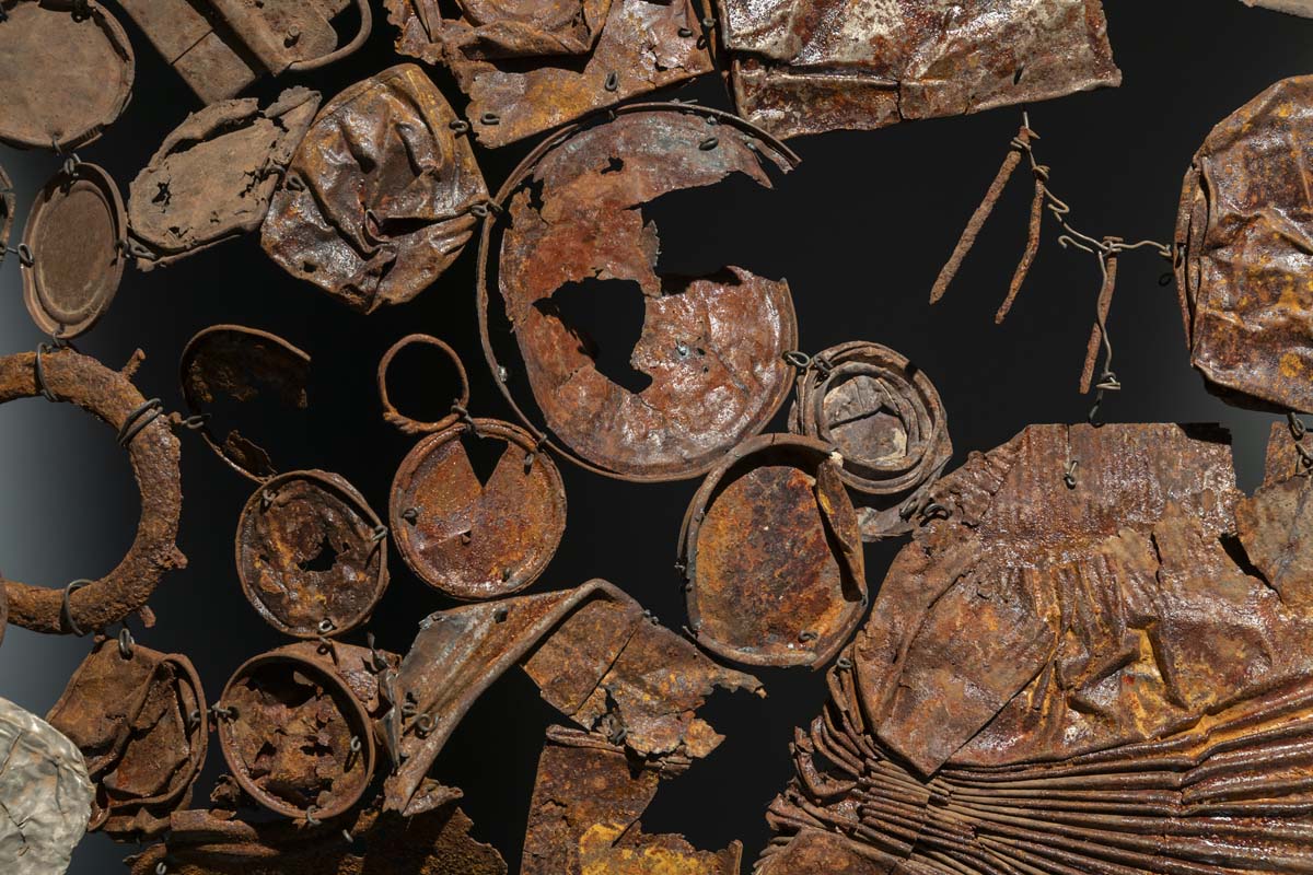 Detail view of Rust Shroud by Phoebe Shuman-Goodier, a collection of flattened rusty metal.