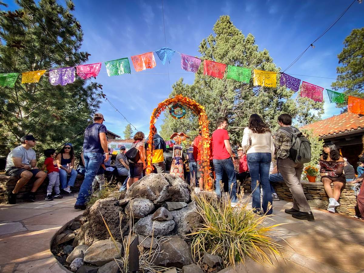 Colorful flags and a marigold portal at Celebraciones de la Gente, one event heating up the winter art season in the Southwest Contemporary Arizona Art Guide.