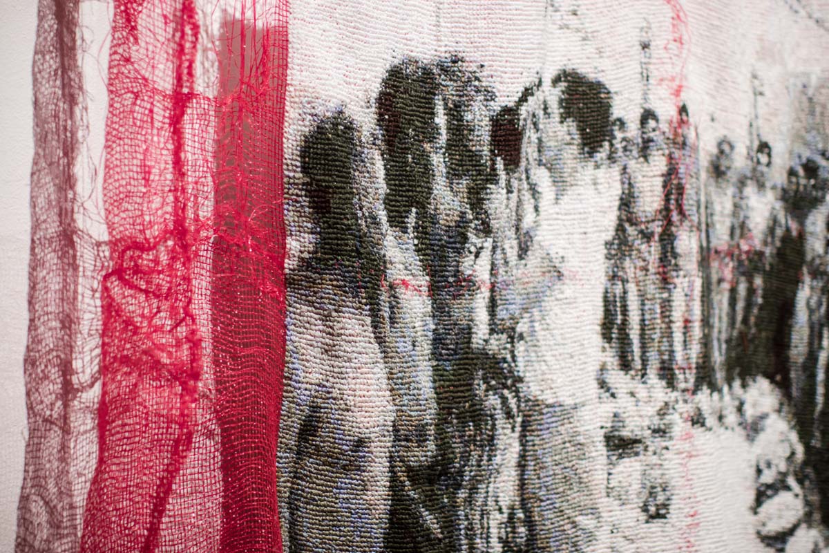 Detail view of a large-scale textile work depicting Mexican laborers (or braceros) doing seasonal agricultural work in the U.S. 