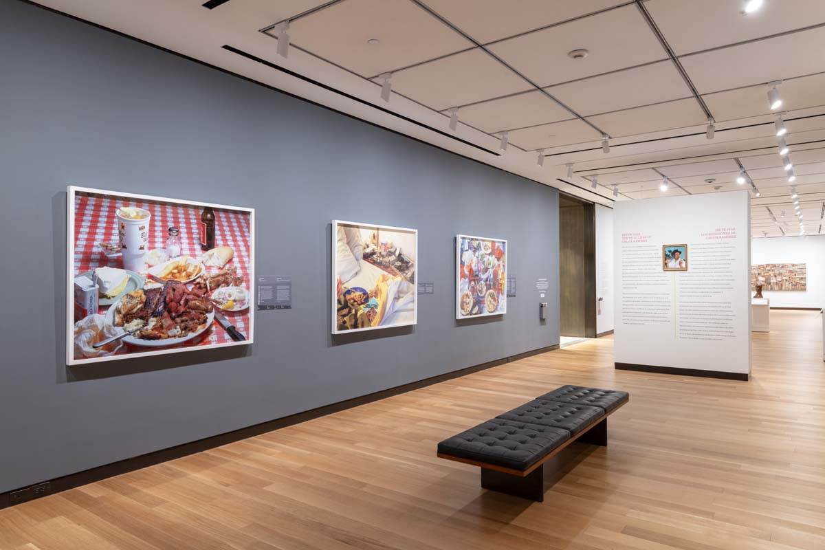 Installation view with large scale photographs by Chuck Ramirez.