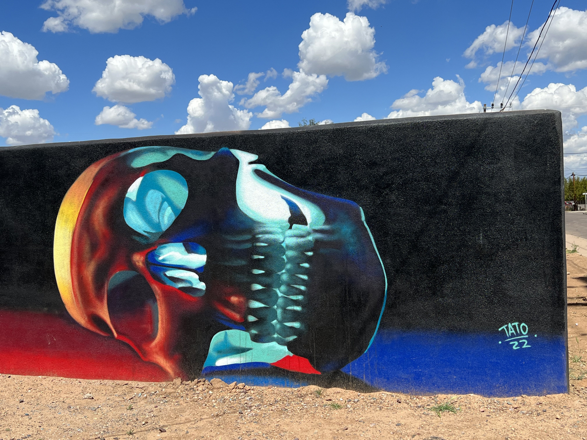 Phoenix mural of a glowing skull by Tato Caraveo, part of the Southwest Mural Guide covering five states including Arizona.