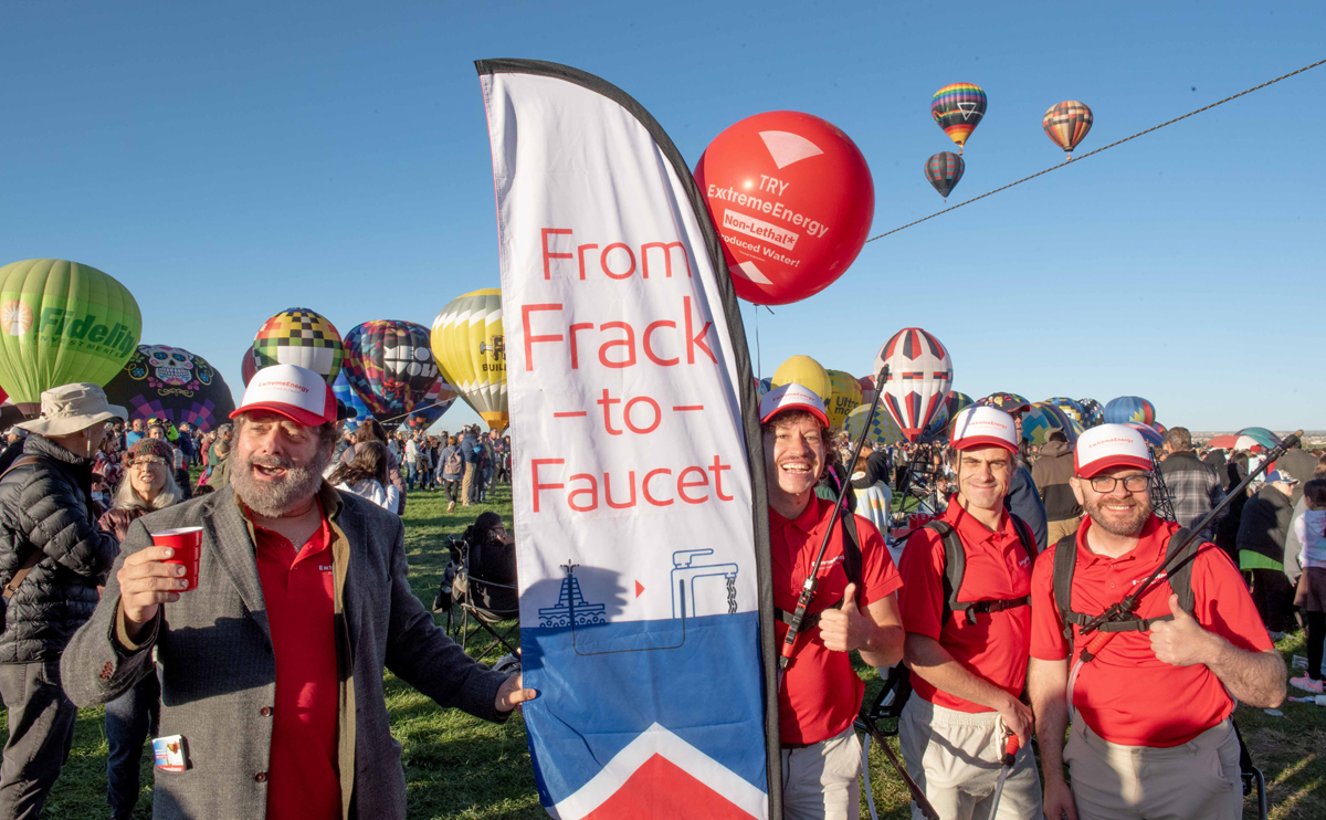 The Yes Men cluster around a banner that reads 