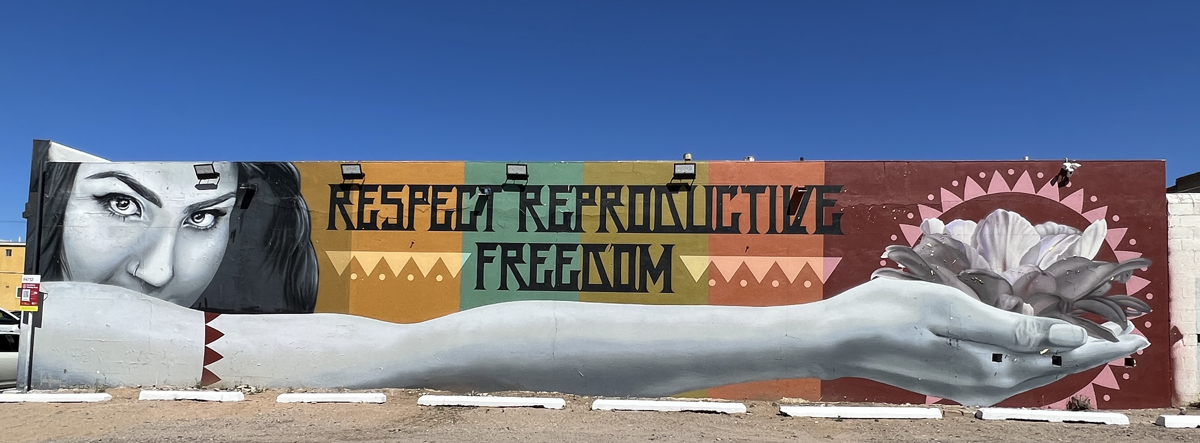 Albuquerque mural of a woman with the words "Respect Reproductive Freedom" by Jodie Herrera in Albuquerque, part of the must-see Southwest Mural Guide.