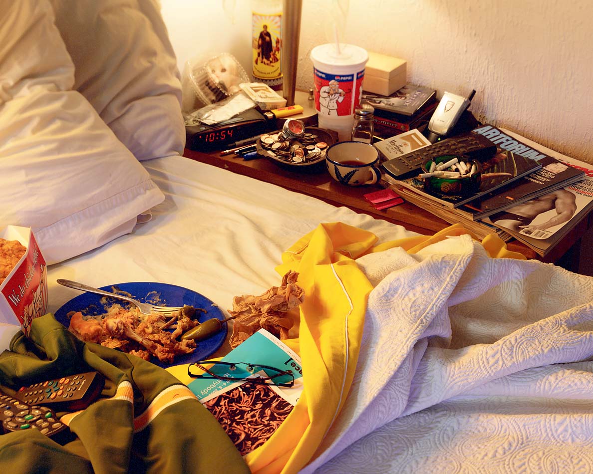 A half eaten KFC meal on a bedside table.