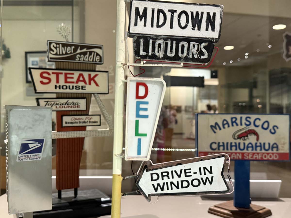A cluster of tiny signs in Jorge Ruiz's Tucson exhibition of miniatures representing Tucson and Nogales.