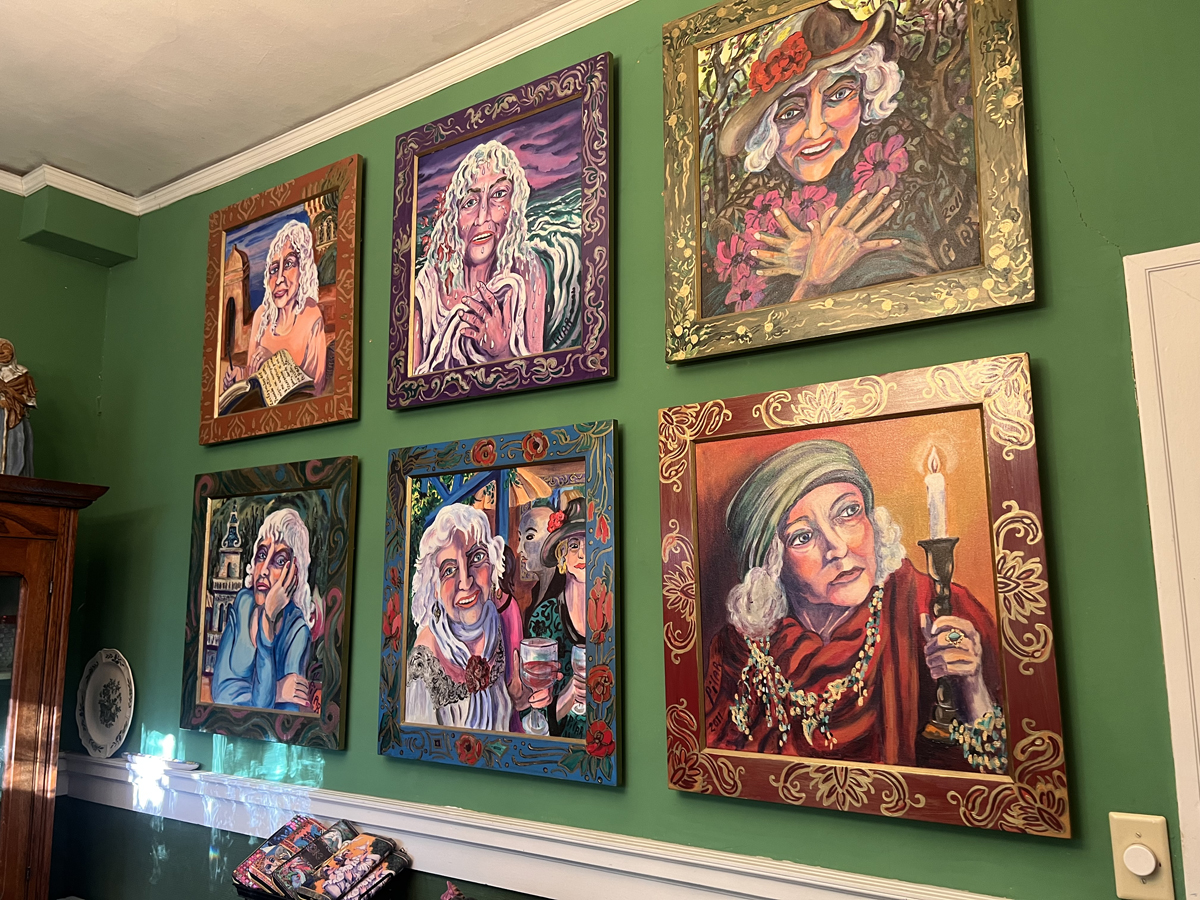 Grid of expressionistic self-portraits by Pilar Pobil on a green wall.