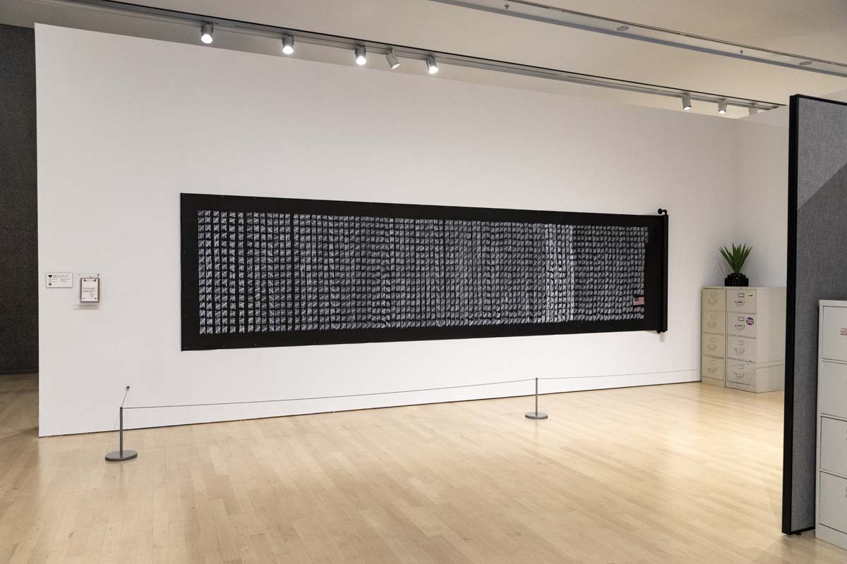 Safwat Saleem's Number of the day: 7,103 comprises of one mark for each of the days the artist spent in the immigration system, adding a small polyester American flag he received during his naturalization ceremony. 