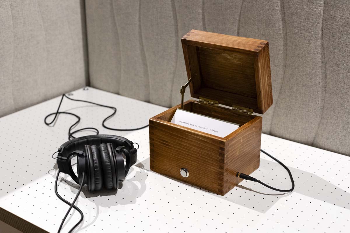 Comfort Food, by Safwat Saleem, with typewritten recipe cards, wooden recipe box, audio player, and headphones