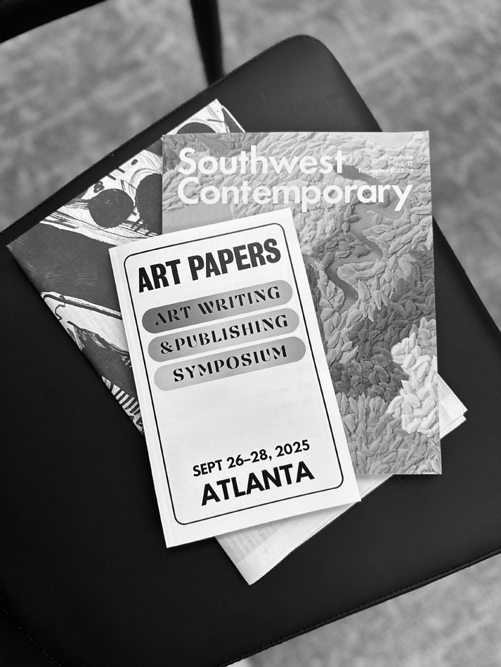 Art Papers Art Writing & Publishing Symposium atop an issue of Southwest Contemporary magazine.