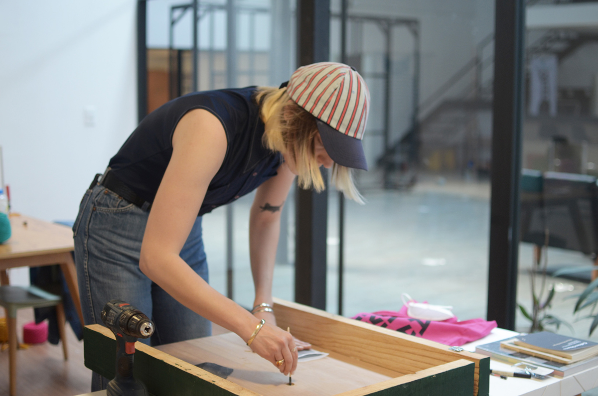 An artist in a stripy baseball cap works in a studio. The Rondo Residency is just one of the top Mexico City residencies on this comprehensive list for visual artists and curators.