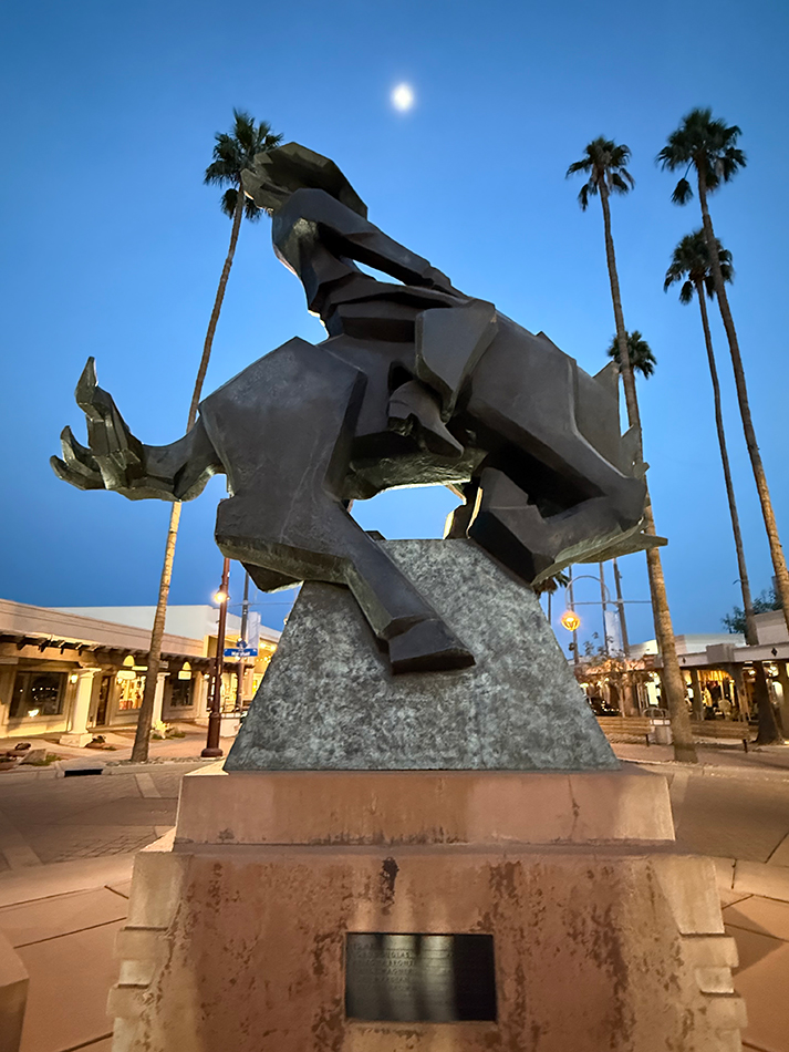 Sculpture by Ed Mell showing a cowboy on a bucking bronco.