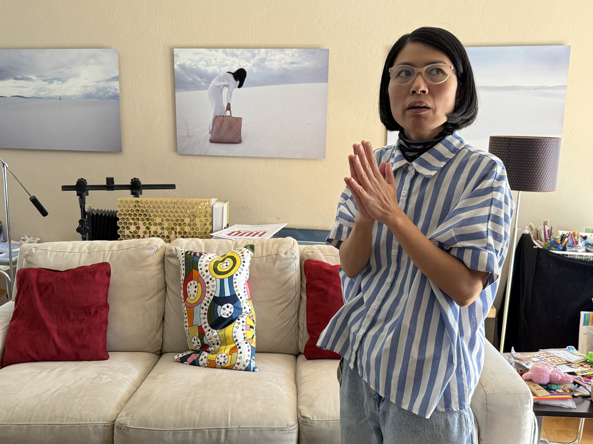Vietnamese American artist Anh-Thuy Nguyen in front of her Thuy & Sand series.