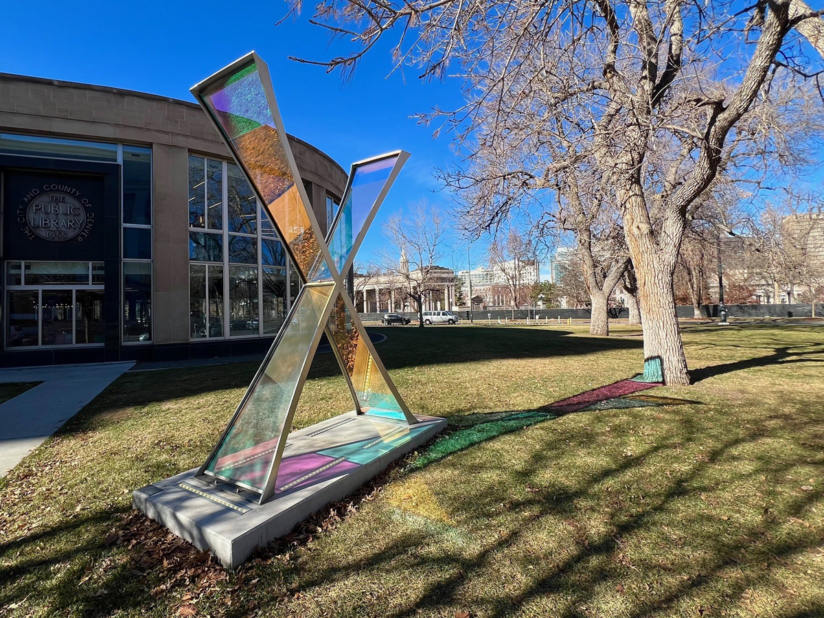 Public artwork titled Equis by Paula Castillo in downtown Denver, with a public library nearby.