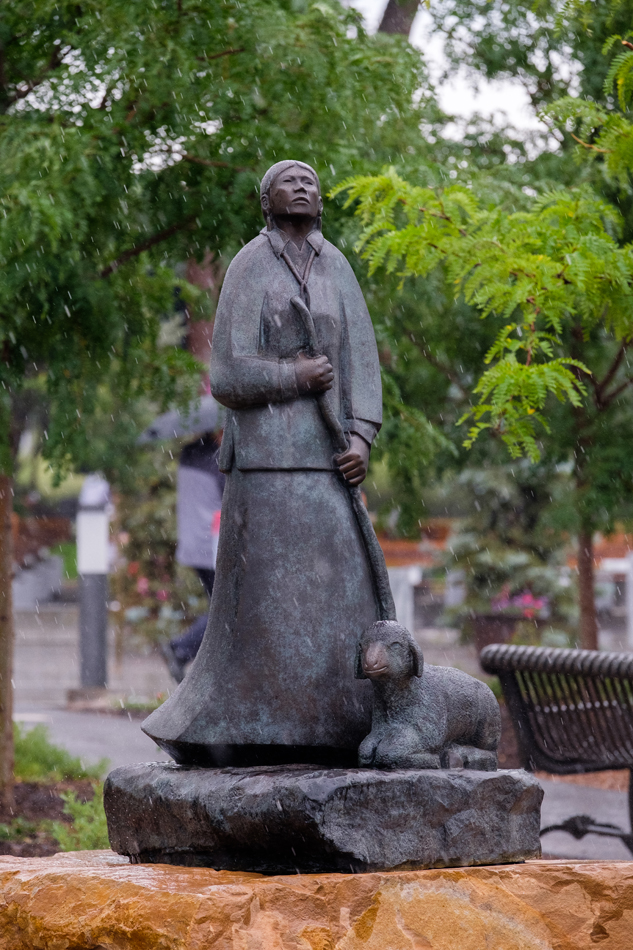 Bronze figurative sculpture by Allan Houser of a Native woman with a lamb.