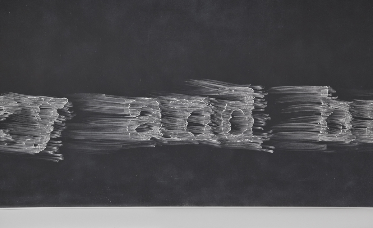 Installation Rush at Cookie Factory, showing smudged text on a chalkboard surface.