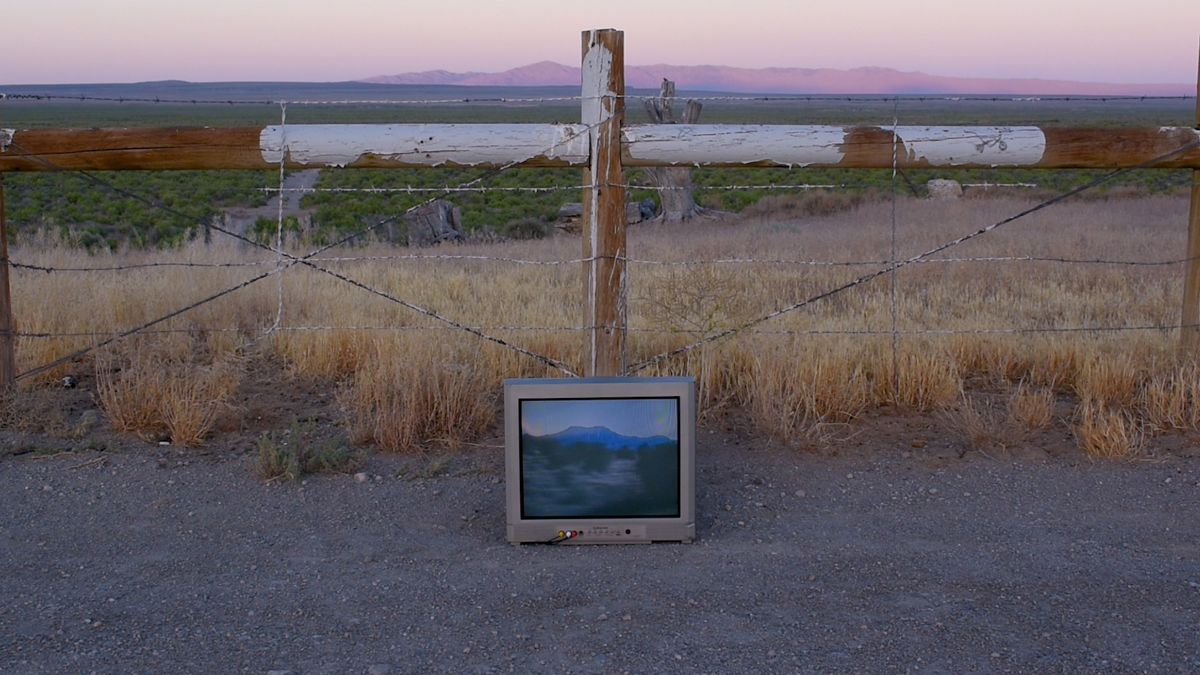 Site-specific art installation incorporating a television and a fence.