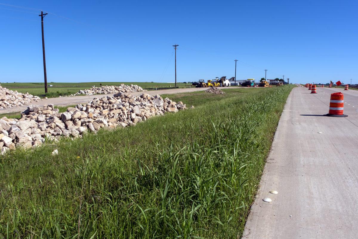 Photograph of a roadside with rubble.