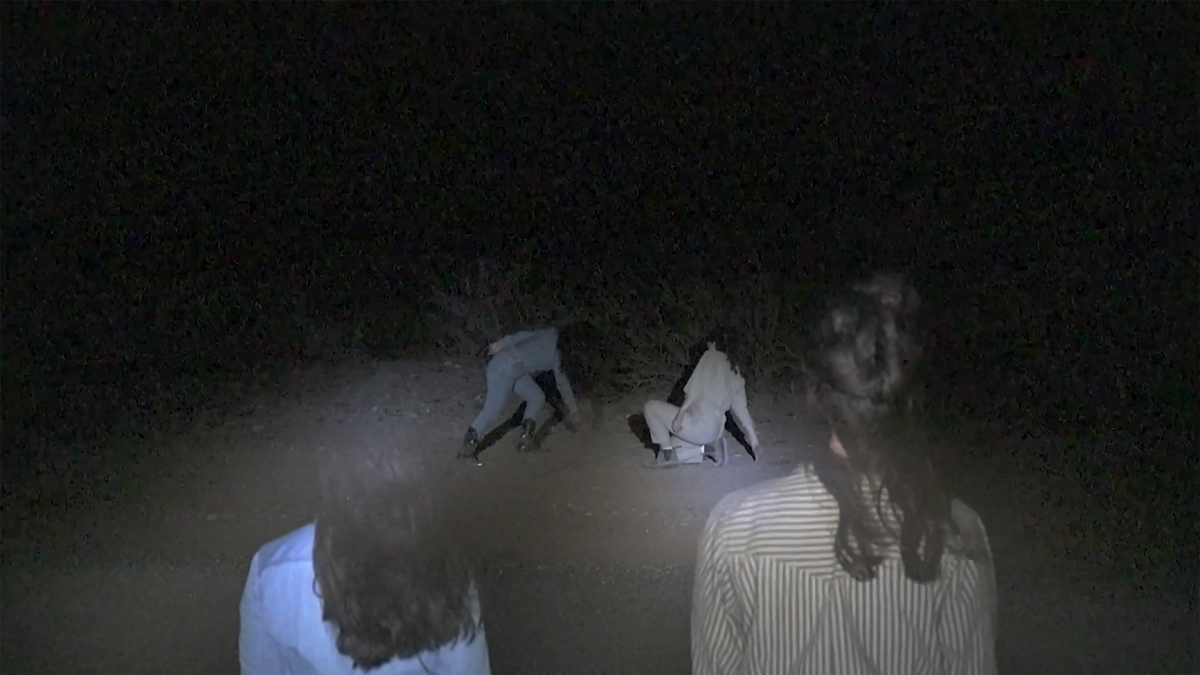 Video still of a performance artwork.