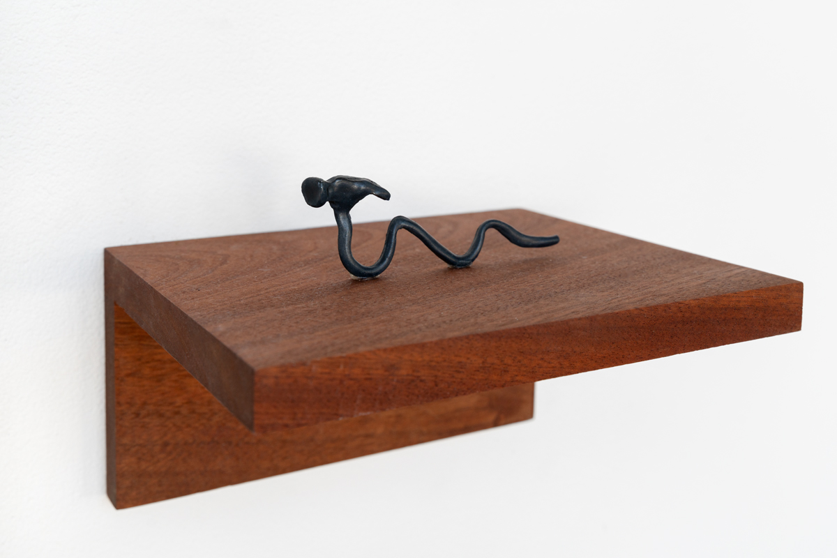 Sculpture of a small, warped hammer.